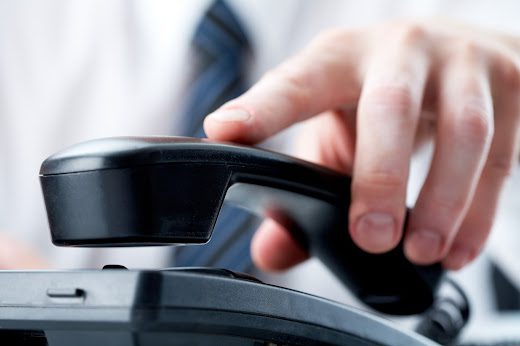 A man picking up a telephone