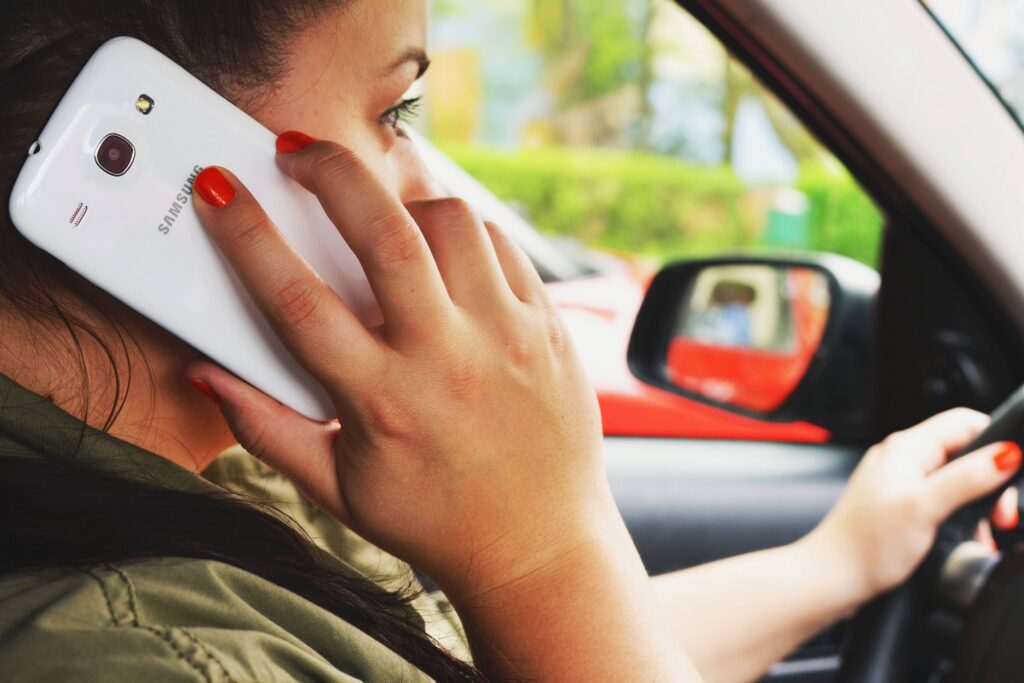 Person driving while holding phone